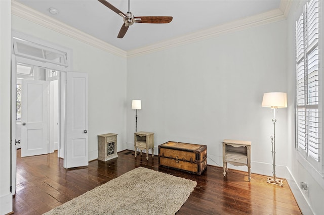 living area featuring crown molding, ceiling fan, dark wood-style floors, and a healthy amount of sunlight
