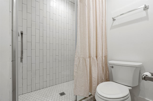 bathroom with toilet and a shower stall