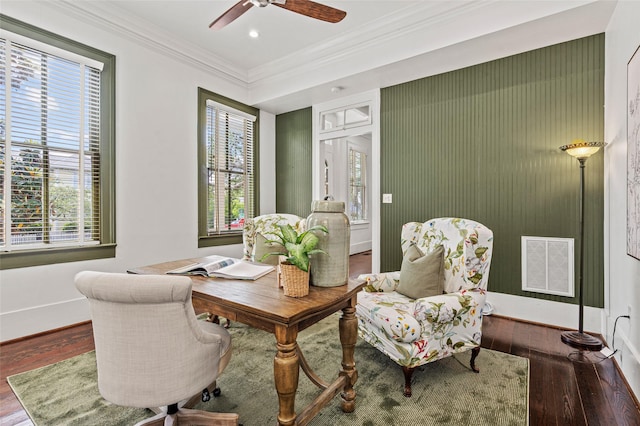 living area featuring crown molding, ceiling fan, visible vents, and hardwood / wood-style floors