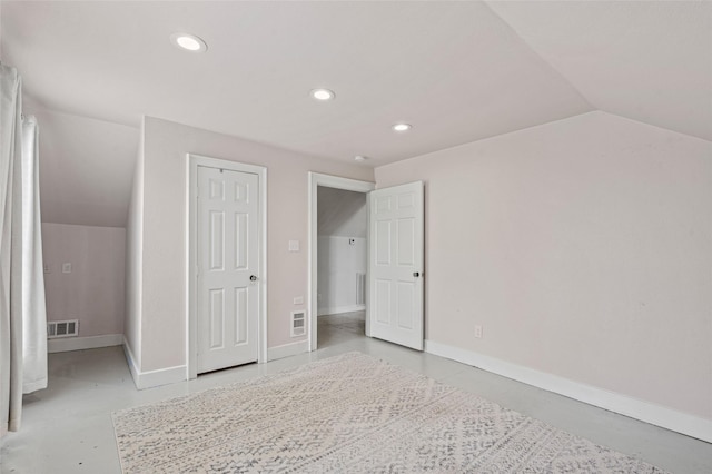 additional living space featuring recessed lighting, baseboards, finished concrete floors, vaulted ceiling, and visible vents