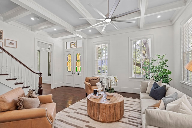 living area featuring dark wood-type flooring, coffered ceiling, stairs, and beamed ceiling