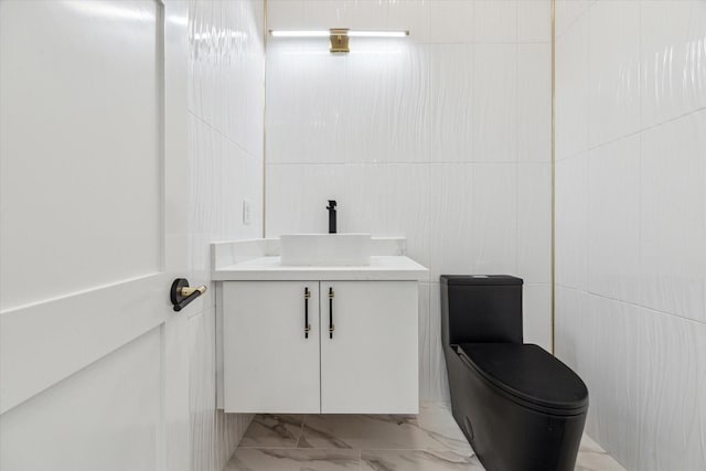 bathroom featuring vanity, toilet, and marble finish floor