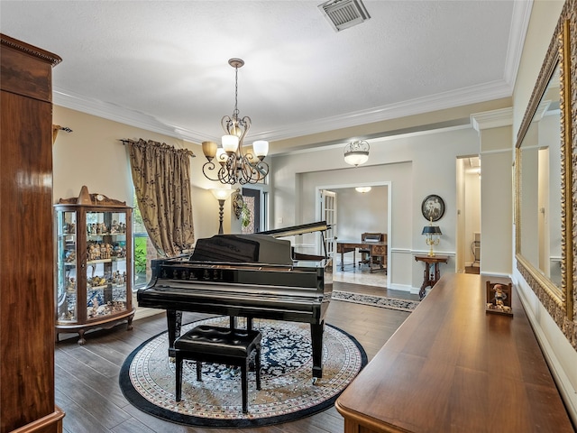 sitting room featuring visible vents, crown molding, a notable chandelier, and hardwood / wood-style flooring