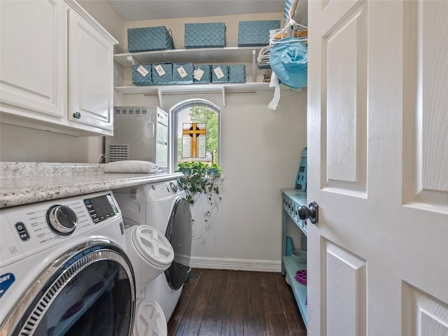 laundry room featuring cabinet space, baseboards, dark wood finished floors, and washing machine and dryer
