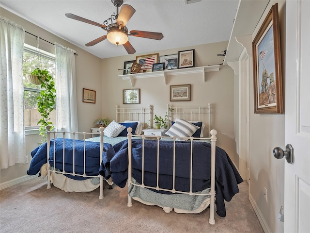 bedroom with baseboards, a ceiling fan, and carpet flooring