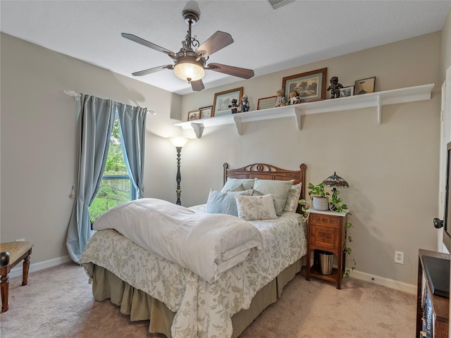 bedroom featuring baseboards, a ceiling fan, and light colored carpet