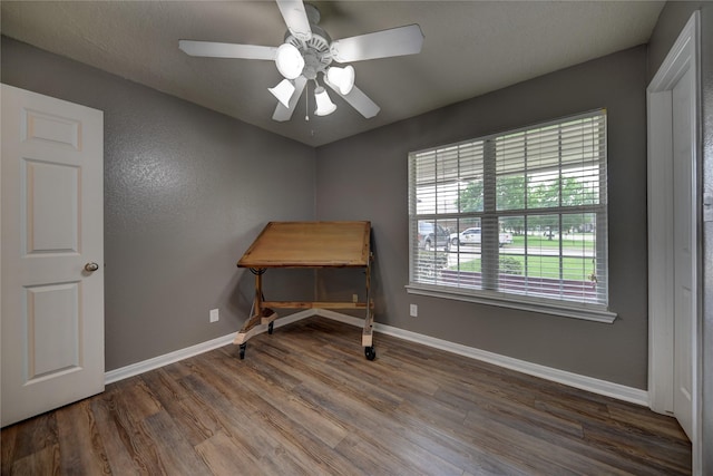 office with baseboards, ceiling fan, and wood finished floors