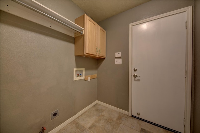 washroom with washer hookup, electric dryer hookup, cabinet space, light tile patterned floors, and baseboards