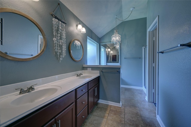 full bathroom featuring double vanity, a sink, lofted ceiling, and tile patterned flooring