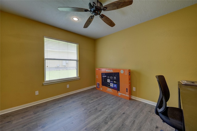 unfurnished office with baseboards, ceiling fan, recessed lighting, and wood finished floors
