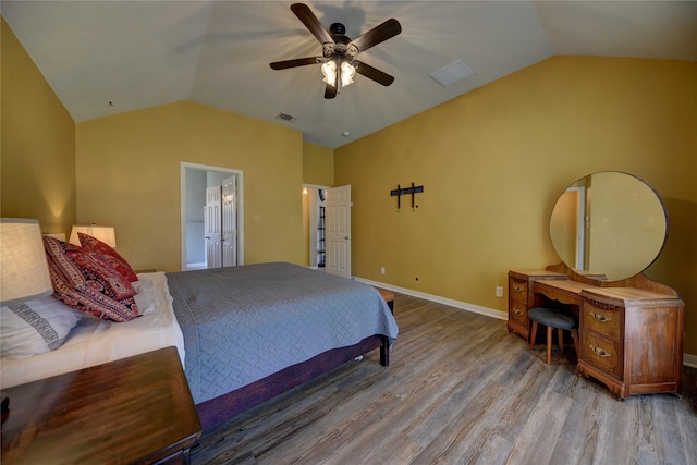 bedroom with a ceiling fan, baseboards, wood finished floors, lofted ceiling, and visible vents