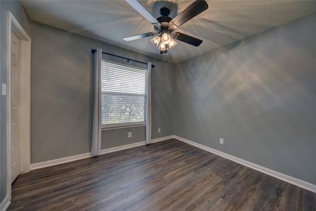 empty room with baseboards, a ceiling fan, and dark wood-style flooring