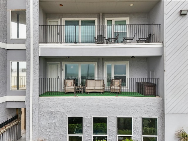 7600 Seawall Blvd Unit 113, Galveston, TX 77551 - rear view of house featuring stucco siding and a balcony