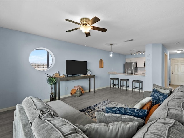 7600 Seawall Blvd Unit 113, Galveston, TX 77551 - living room with baseboards, ceiling fan, visible vents, and wood finished floors