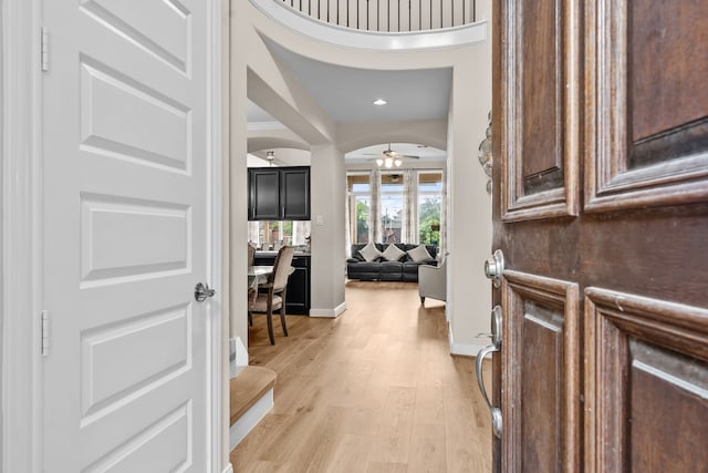 3422 Leaning Willow Dr, Katy, TX 77494 - entrance foyer with ceiling fan, arched walkways, baseboards, light wood finished floors, and recessed lighting