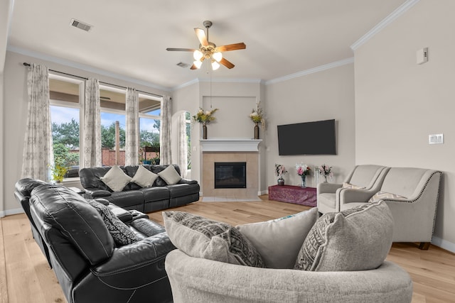 3422 Leaning Willow Dr, Katy, TX 77494 - living room featuring visible vents, ornamental molding, wood finished floors, baseboards, and ceiling fan