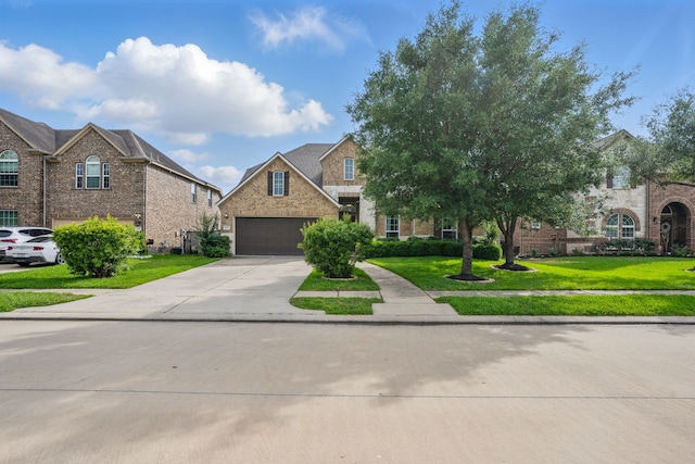 3422 Leaning Willow Dr, Katy, TX 77494 - view of front of house featuring a garage, a front yard, driveway, and brick siding