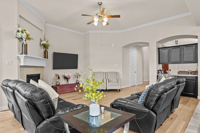 3422 Leaning Willow Dr, Katy, TX 77494 - living area featuring crown molding, arched walkways, light wood-style flooring, and a ceiling fan