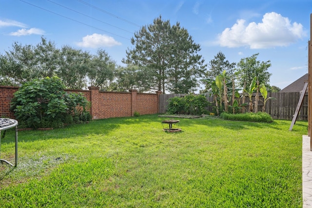 3422 Leaning Willow Dr, Katy, TX 77494 - view of yard with a fire pit and a fenced backyard