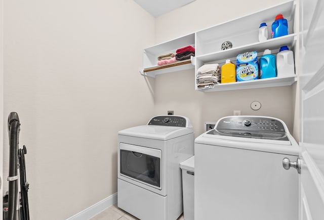 3422 Leaning Willow Dr, Katy, TX 77494 - clothes washing area featuring light tile patterned floors, baseboards, laundry area, and washing machine and clothes dryer