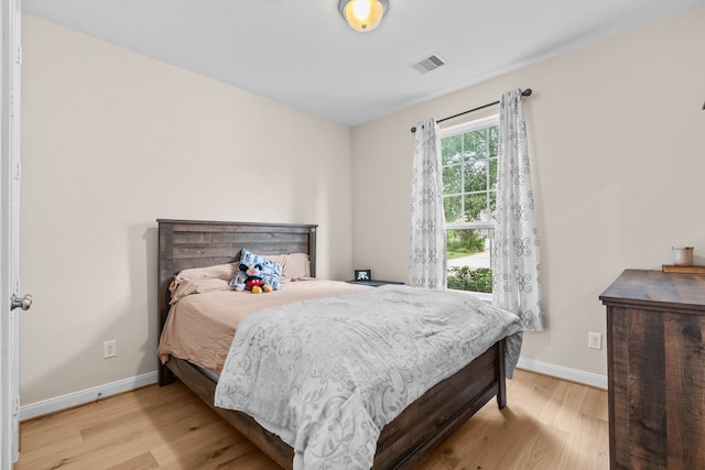 3422 Leaning Willow Dr, Katy, TX 77494 - bedroom featuring baseboards, wood finished floors, and visible vents