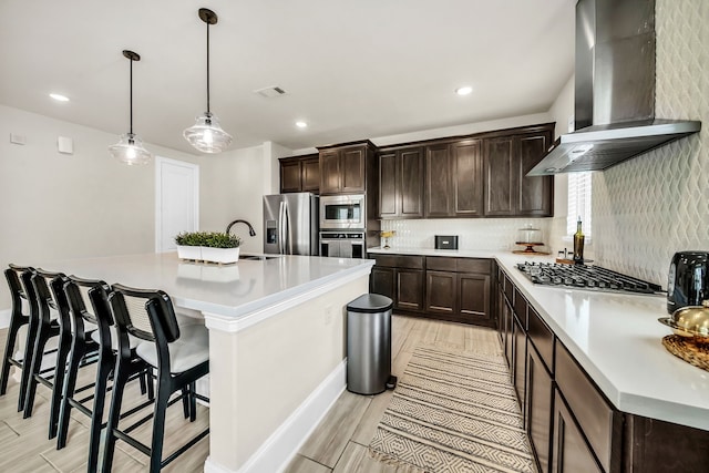 32927 Franklin Brooks Dr, Brookshire, TX 77423 - kitchen with wall chimney range hood, visible vents, appliances with stainless steel finishes, dark brown cabinets, and light countertops