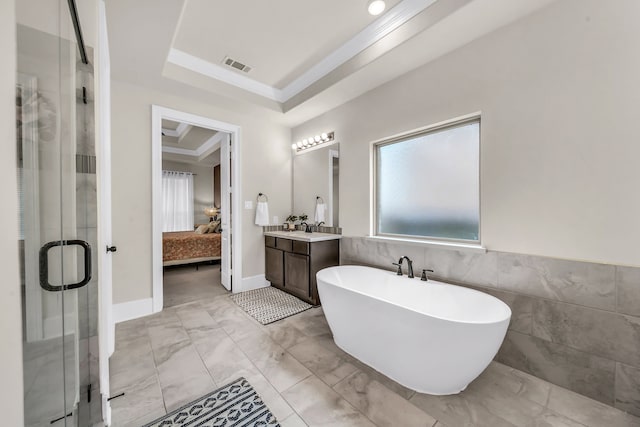 32927 Franklin Brooks Dr, Brookshire, TX 77423 - ensuite bathroom featuring visible vents, marble finish floor, connected bathroom, a tray ceiling, and a stall shower