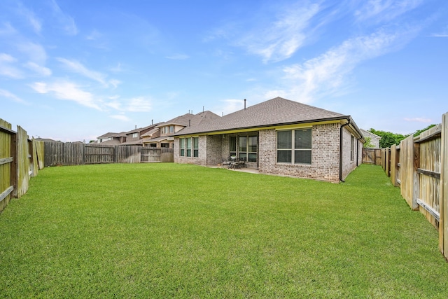 32927 Franklin Brooks Dr, Brookshire, TX 77423 - back of house with brick siding, a fenced backyard, roof with shingles, and a yard