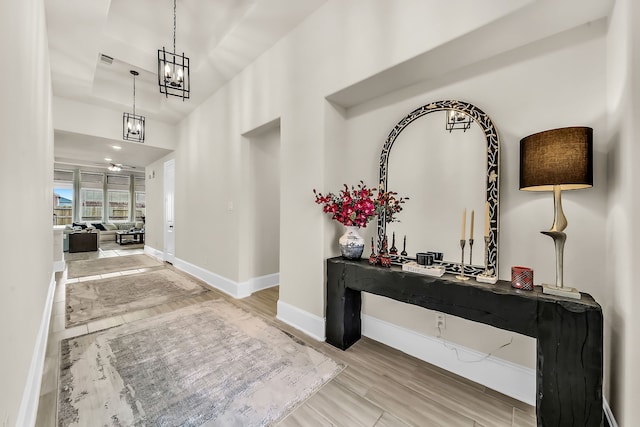 32927 Franklin Brooks Dr, Brookshire, TX 77423 - hall featuring a high ceiling, a chandelier, baseboards, wood finished floors, and visible vents