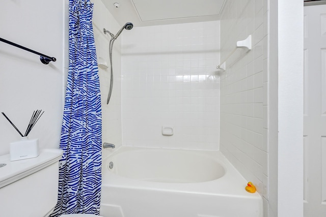 bathroom featuring shower / bath combo and toilet