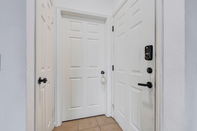 doorway with light tile patterned flooring