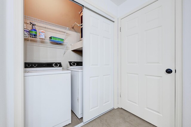 washroom with laundry area, light tile patterned floors, and washer and dryer