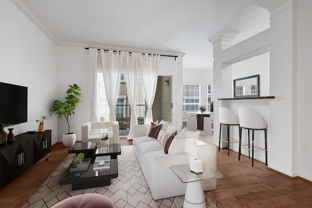 living area featuring ornamental molding and wood finished floors