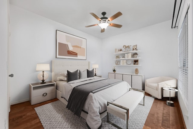 bedroom featuring baseboards, ceiling fan, and wood finished floors