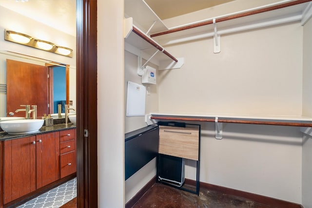walk in closet featuring a sink