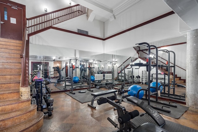 exercise room featuring a high ceiling and visible vents