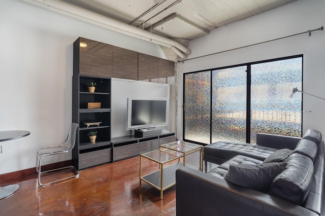 living room featuring baseboards and finished concrete floors