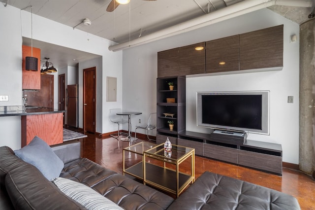 living room featuring baseboards, ceiling fan, and electric panel