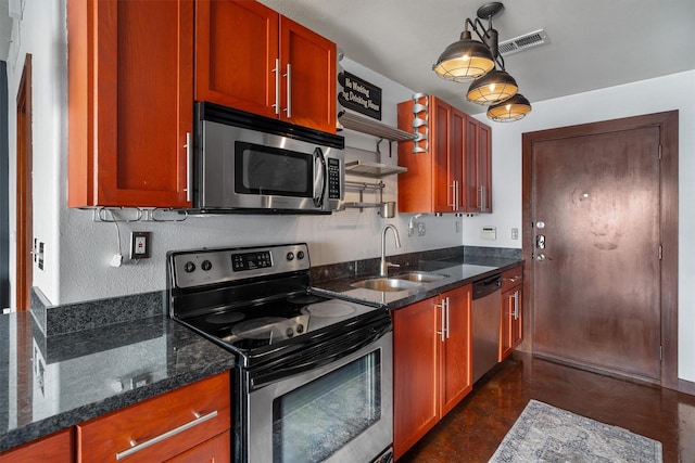 kitchen with appliances with stainless steel finishes, a sink, finished concrete flooring, dark stone counters, and visible vents