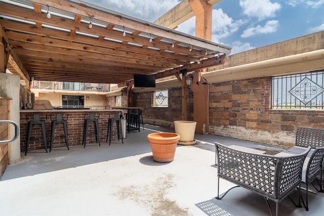 view of patio featuring outdoor wet bar, a pergola, and an outdoor kitchen