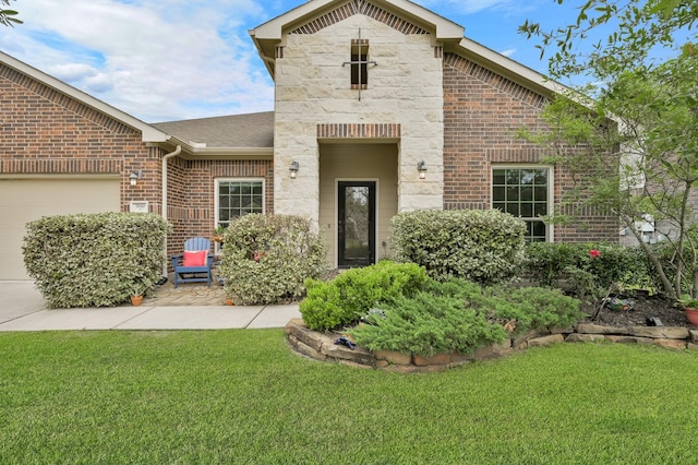 7610 Willow School Dr, Spring, TX 77389 - view of front facade featuring a garage, stone siding, brick siding, and a front yard
