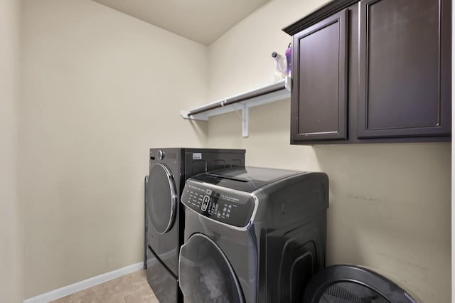 7610 Willow School Dr, Spring, TX 77389 - laundry room with baseboards, cabinet space, and washing machine and clothes dryer