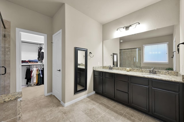 7610 Willow School Dr, Spring, TX 77389 - bathroom featuring a sink, a stall shower, double vanity, and a spacious closet