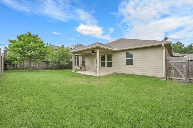 7610 Willow School Dr, Spring, TX 77389 - back of property with a lawn, a ceiling fan, a fenced backyard, and a patio area