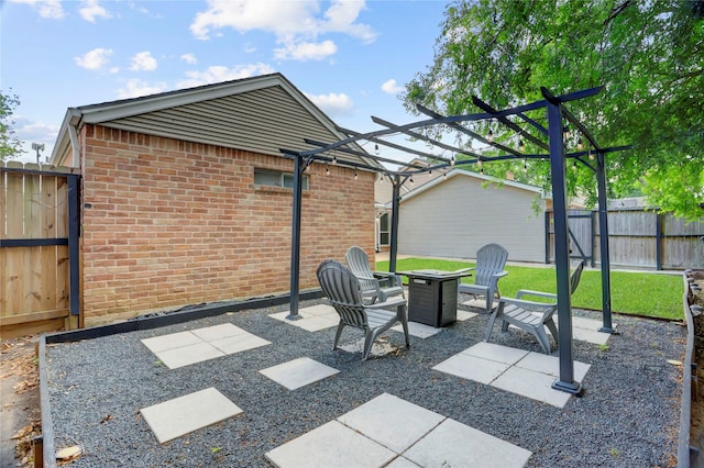 view of patio with a fire pit and fence