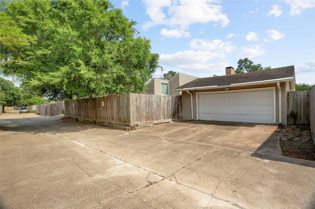 detached garage featuring fence