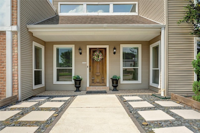 entrance to property with a shingled roof