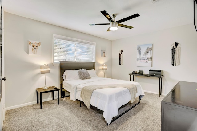 bedroom with light colored carpet, baseboards, and ceiling fan