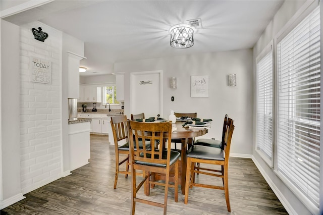 dining room with visible vents, baseboards, and wood finished floors