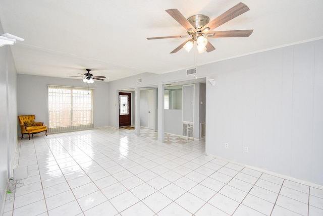 empty room featuring plenty of natural light, visible vents, light tile patterned floors, and ceiling fan